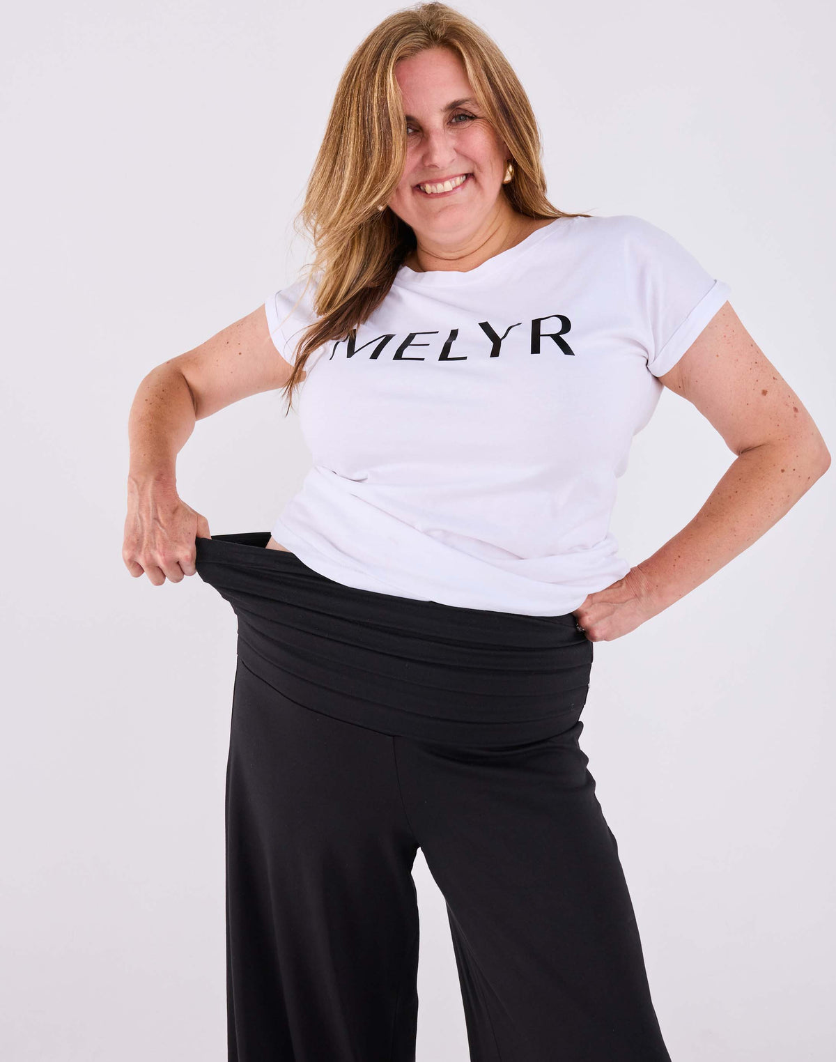 Ravello wide-leg trousers in black on Amy, stretching the MELYRFLEX waistband