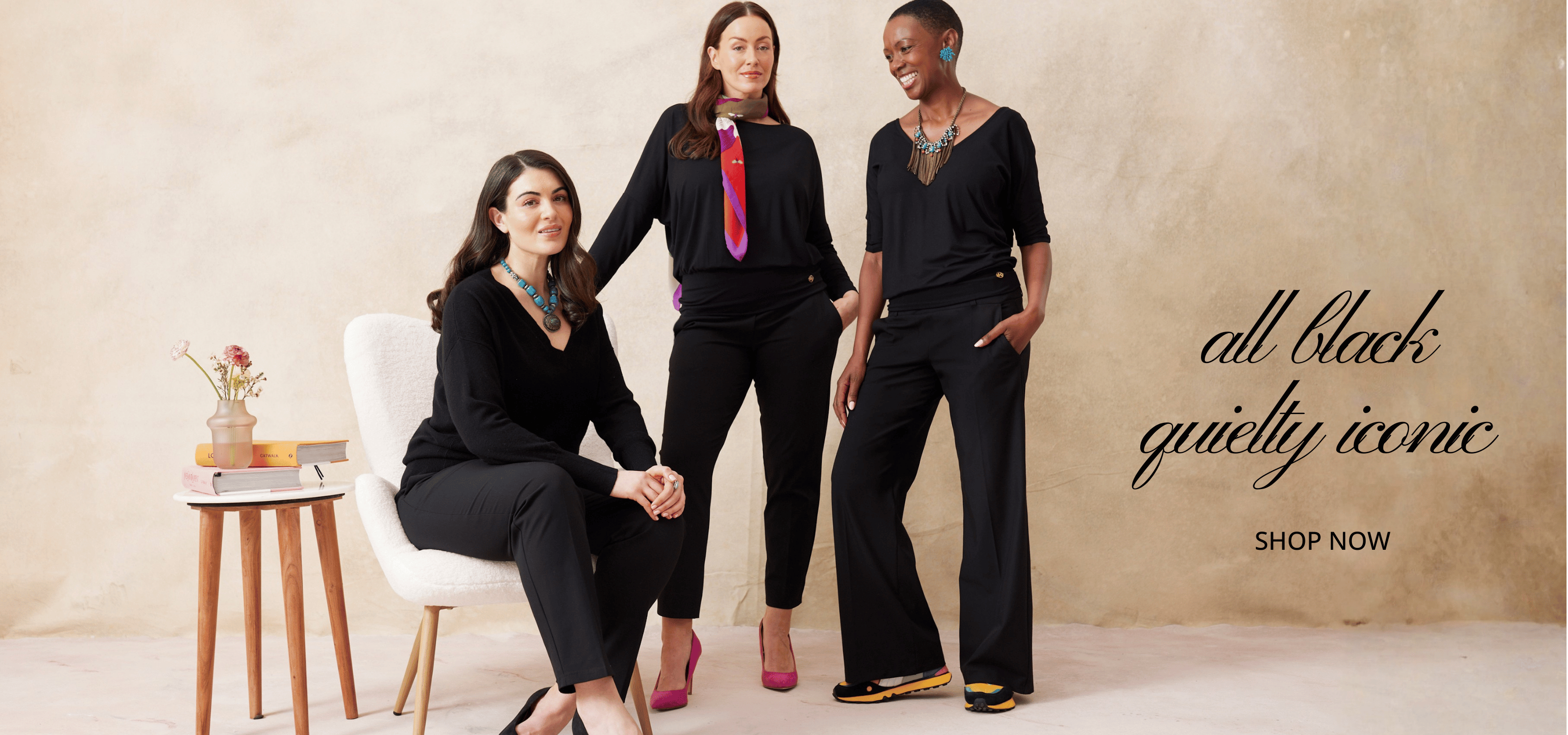 Three women in black Melyr outfits posing together with a promotional text overlay on a beige background.