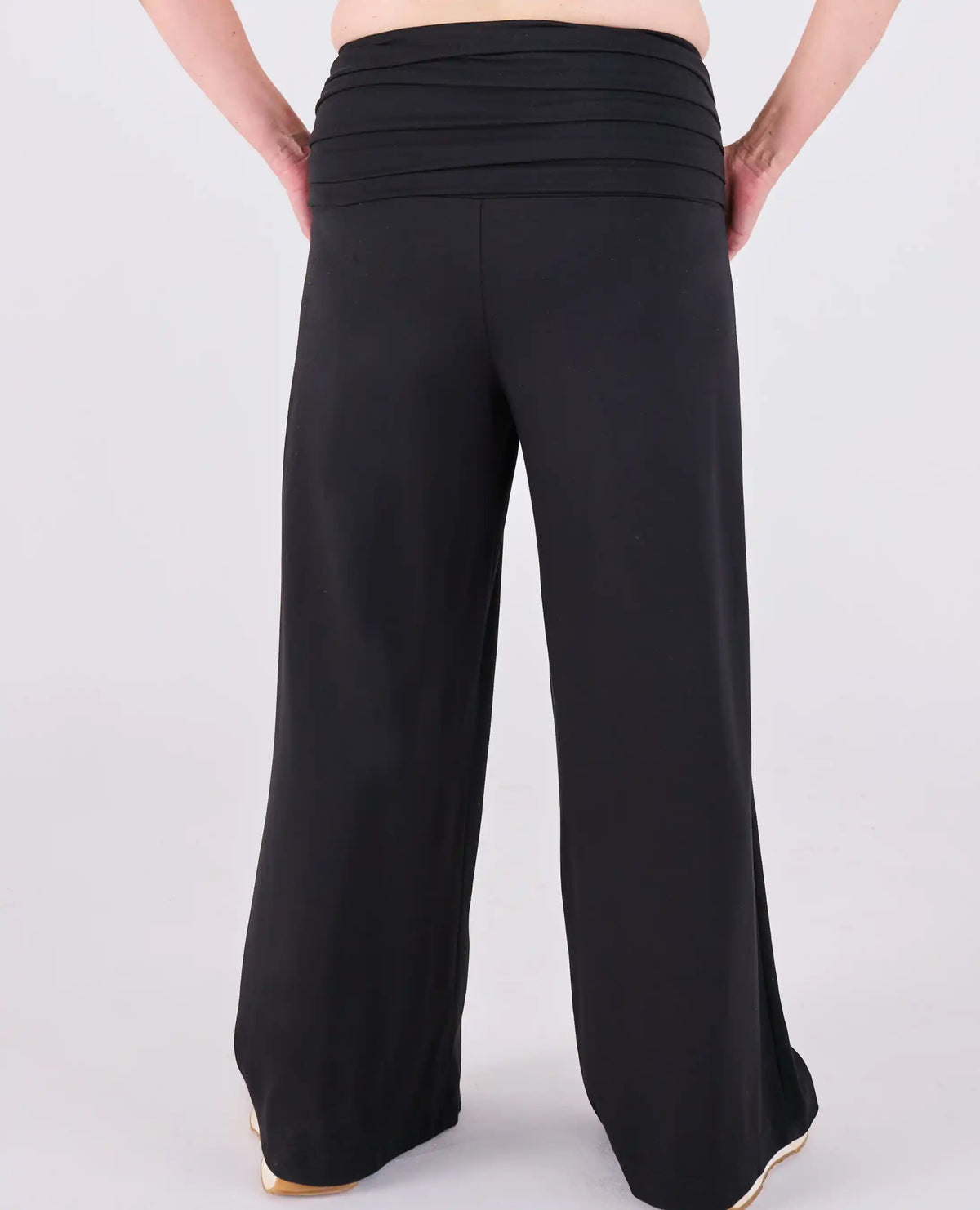 Black Ravello MELYRFLEX wide-leg pants with a gathered elastic waistband, shown from the back on a model against a light gray studio background.