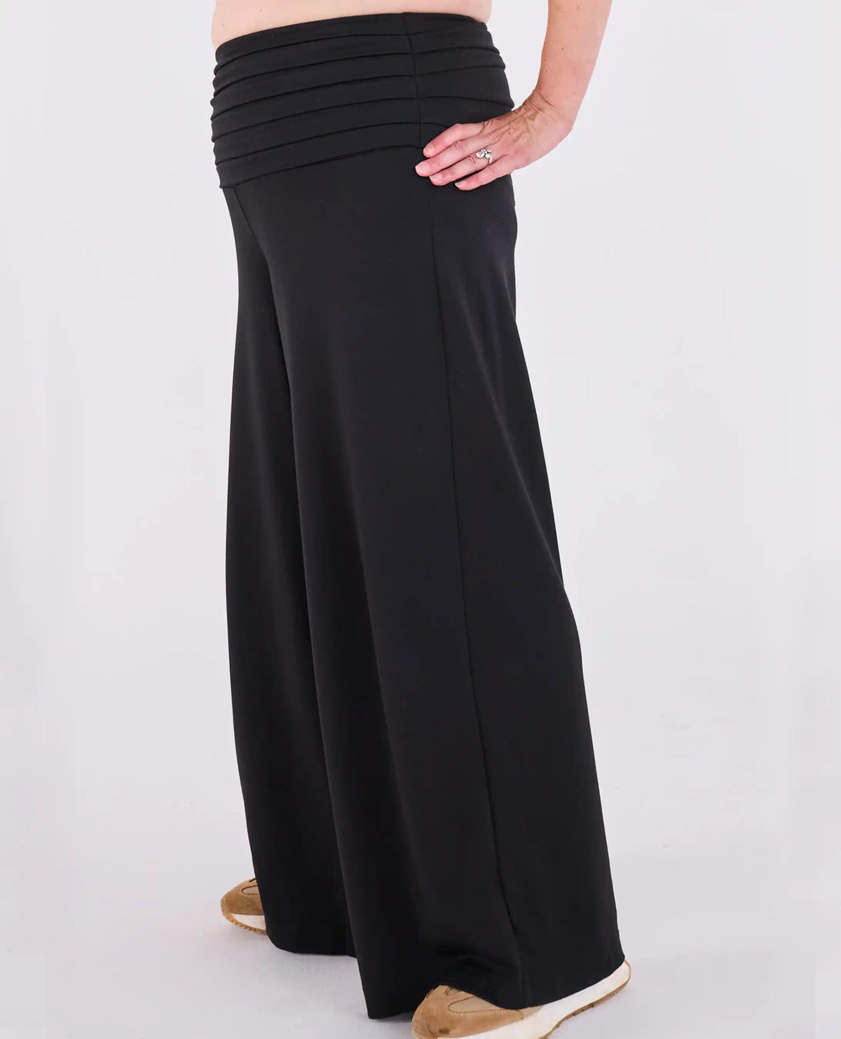 Black Ravello MELYRFLEX wide-leg pants with a gathered pleated waistband, shown on a model from the waist down against a plain white studio background.
