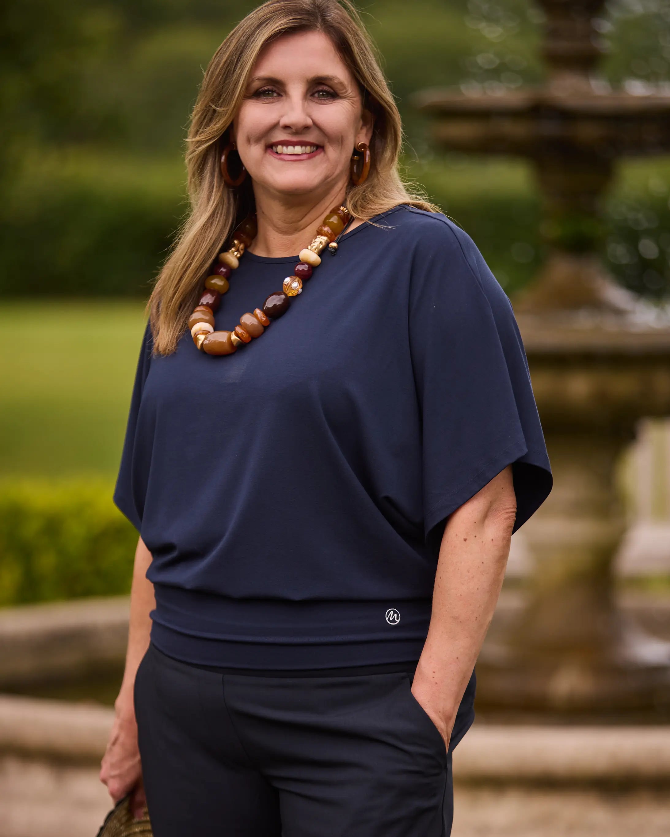 model wearing navy kimono sleeve jersey top with boat neckline by Melyr