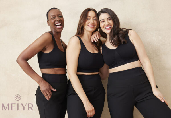 Three models of different ages and sizes wearing MELYRFLEX Sienna trousers in black